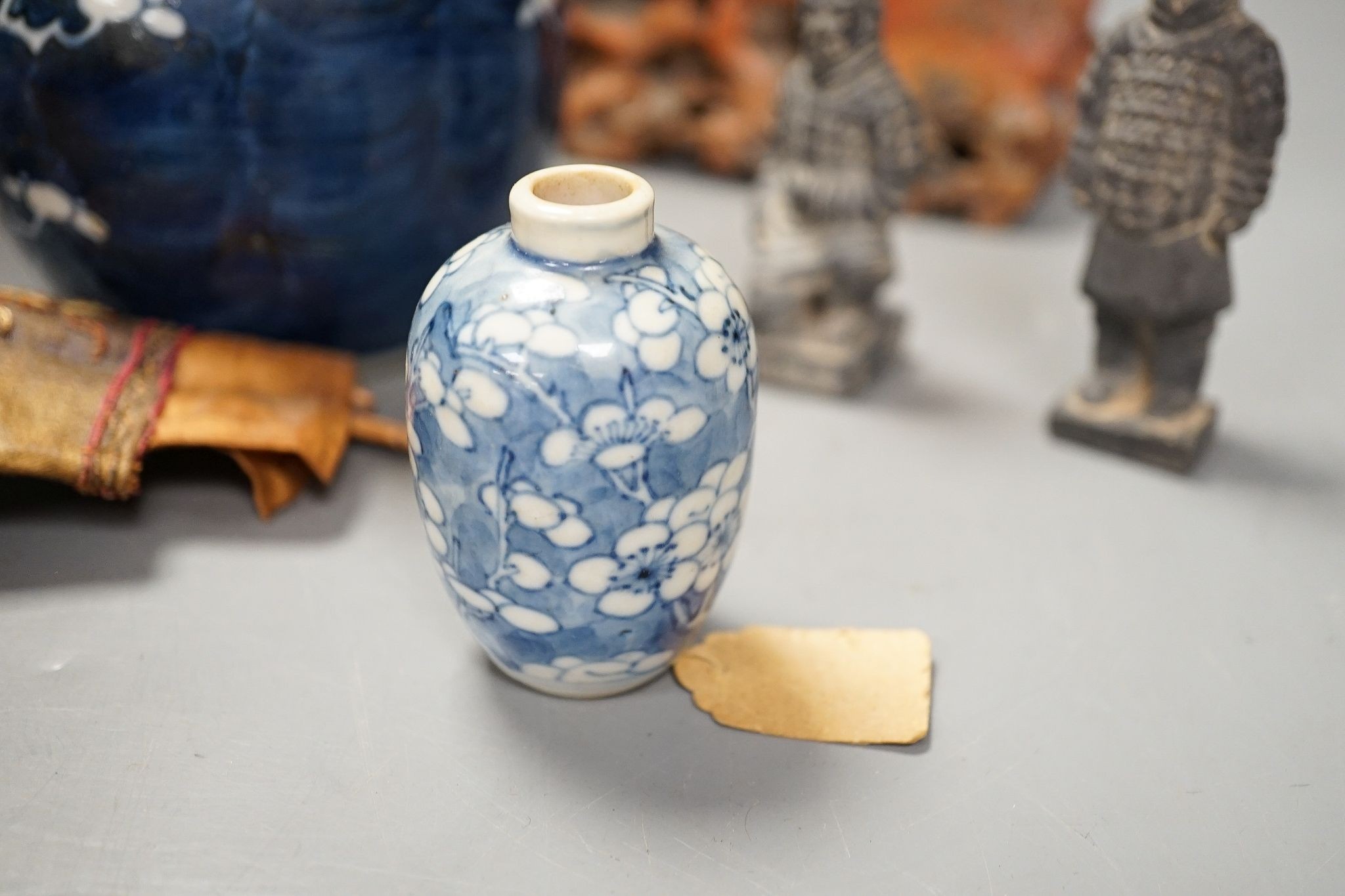 A Chinese carving of a deity, 32cm, a prunus jar, miniature vase, etc.